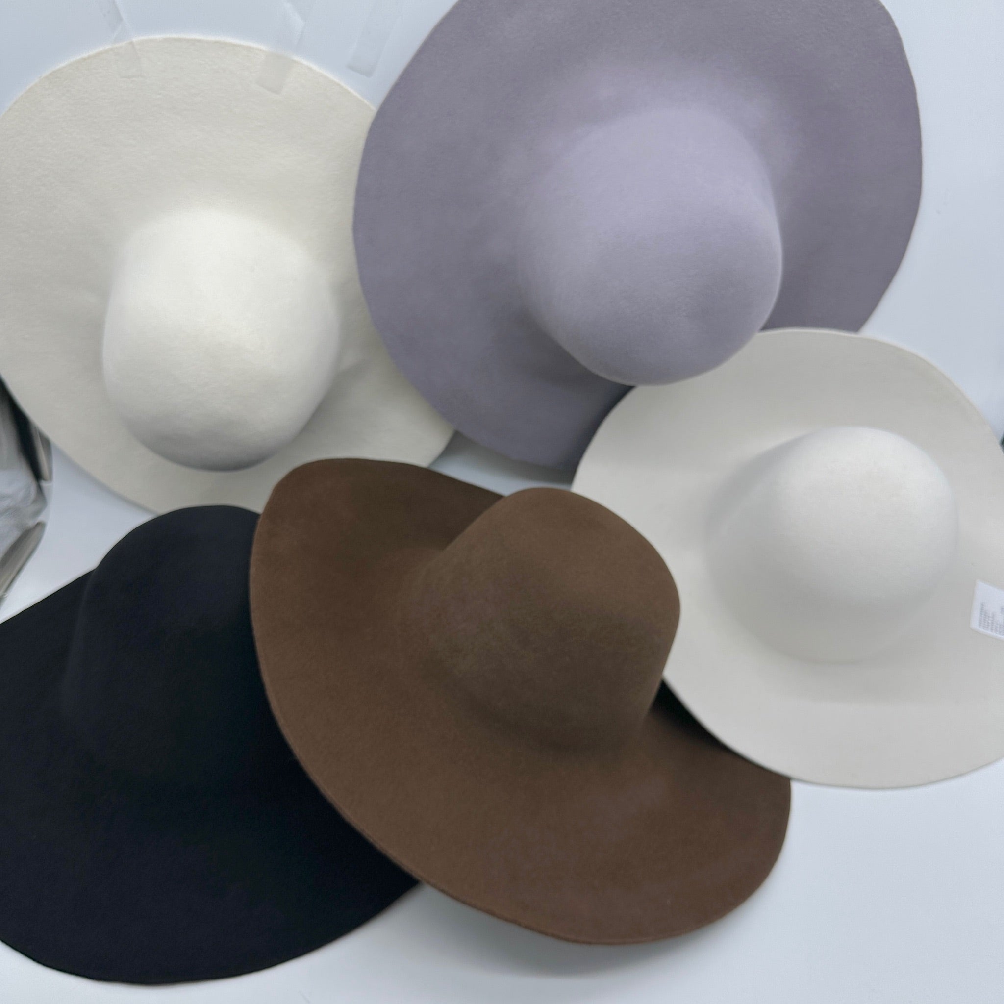 Five wide-brim fur felt hat bodies in black, brown, cream, off white