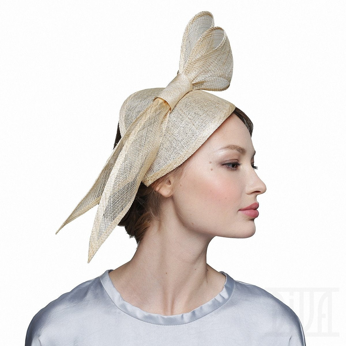 A light beige straw hat with a large bow.