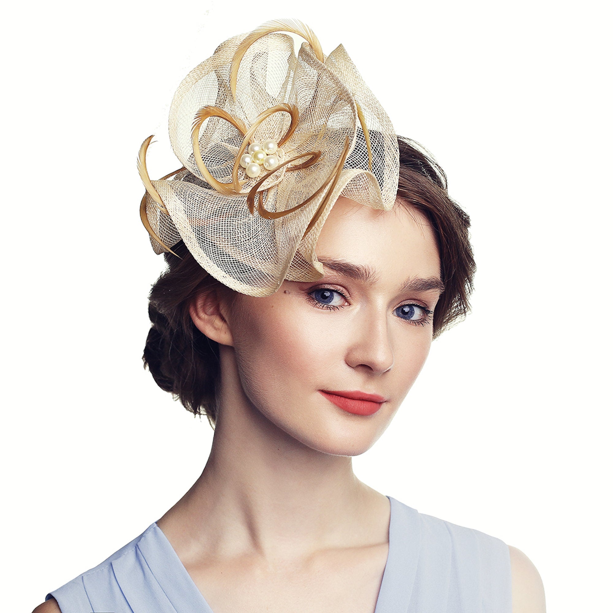 Beige and gold headpiece with a floral design. The headpiece features a layered, open weave fabric with gold accents and a cluster of pearls at the center.