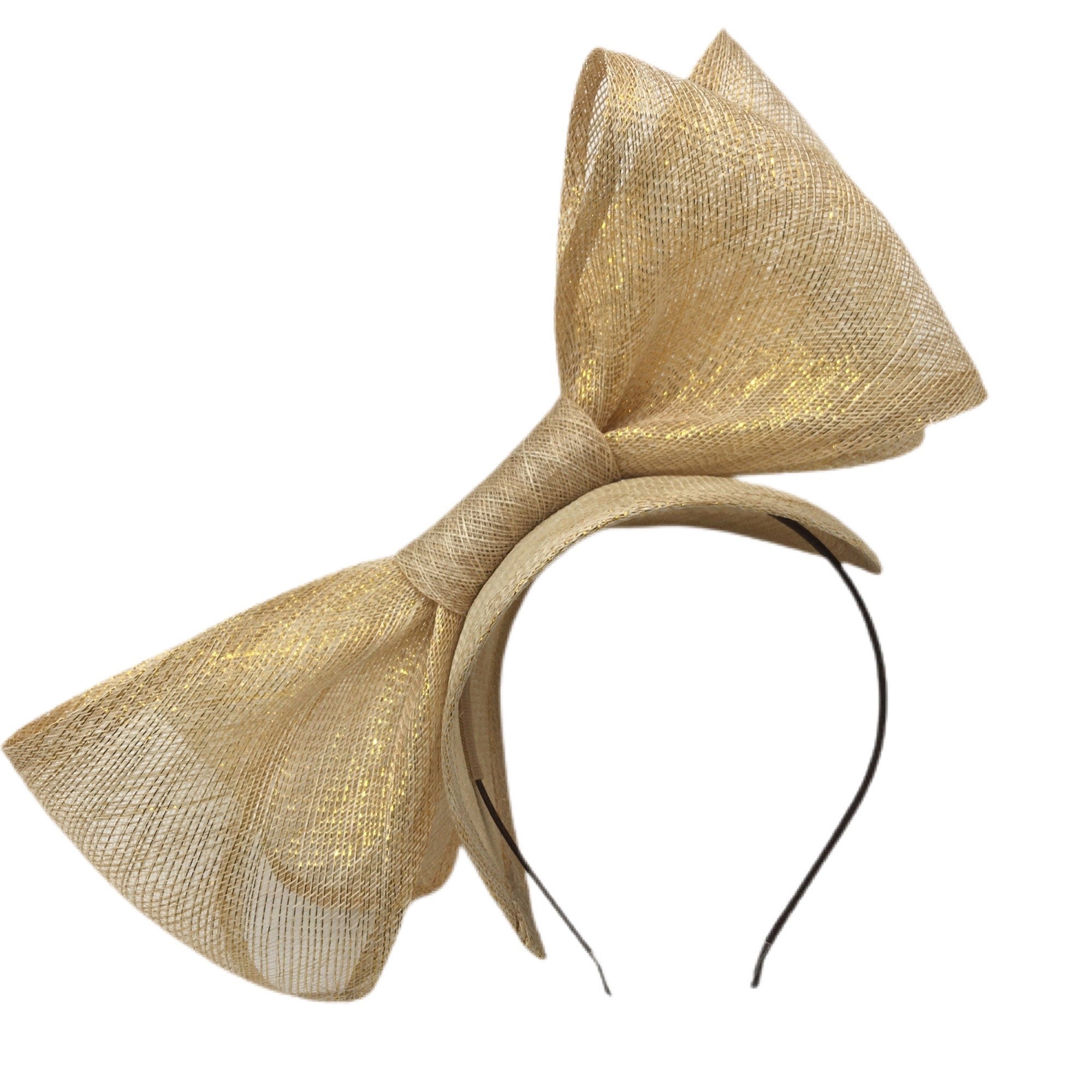 A gold headband fascinator with a large bow.