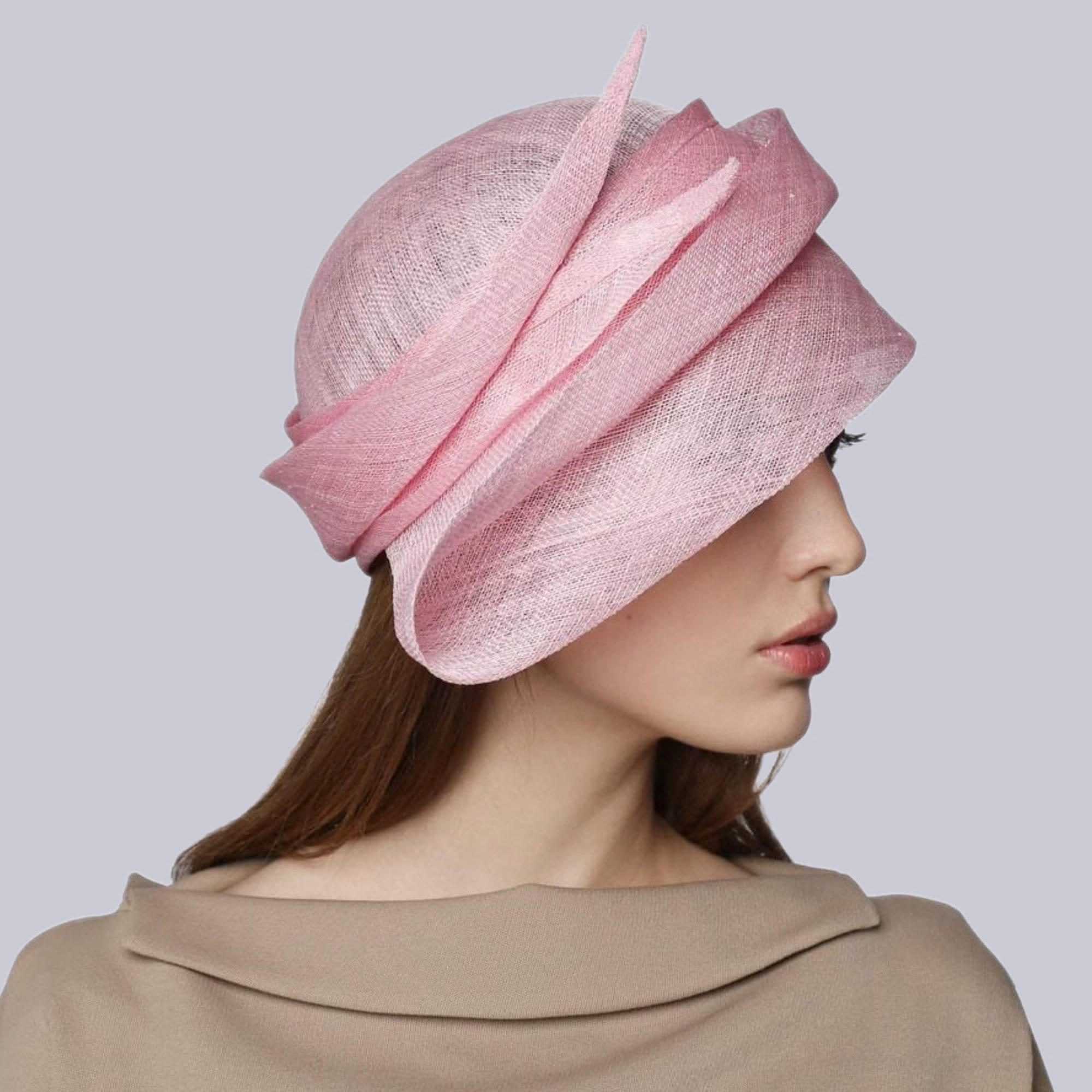 Pink hat is made of a soft, textured fabric.