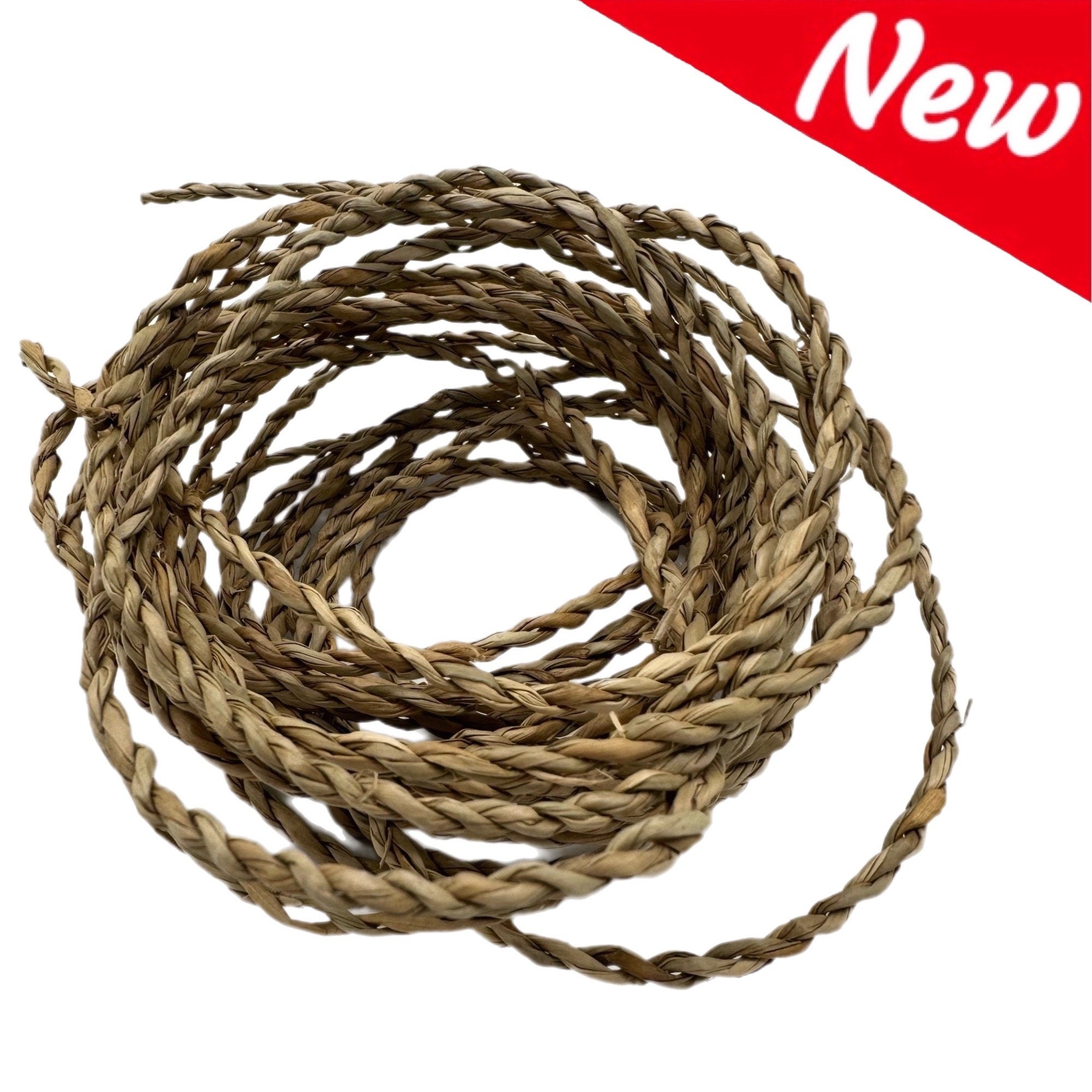 A close-up of a natural, light brown, braided rope made of woven raffia straw. The rope is coiled in a circle and is approximately 1/2 inch thick. The rope is new and unused.