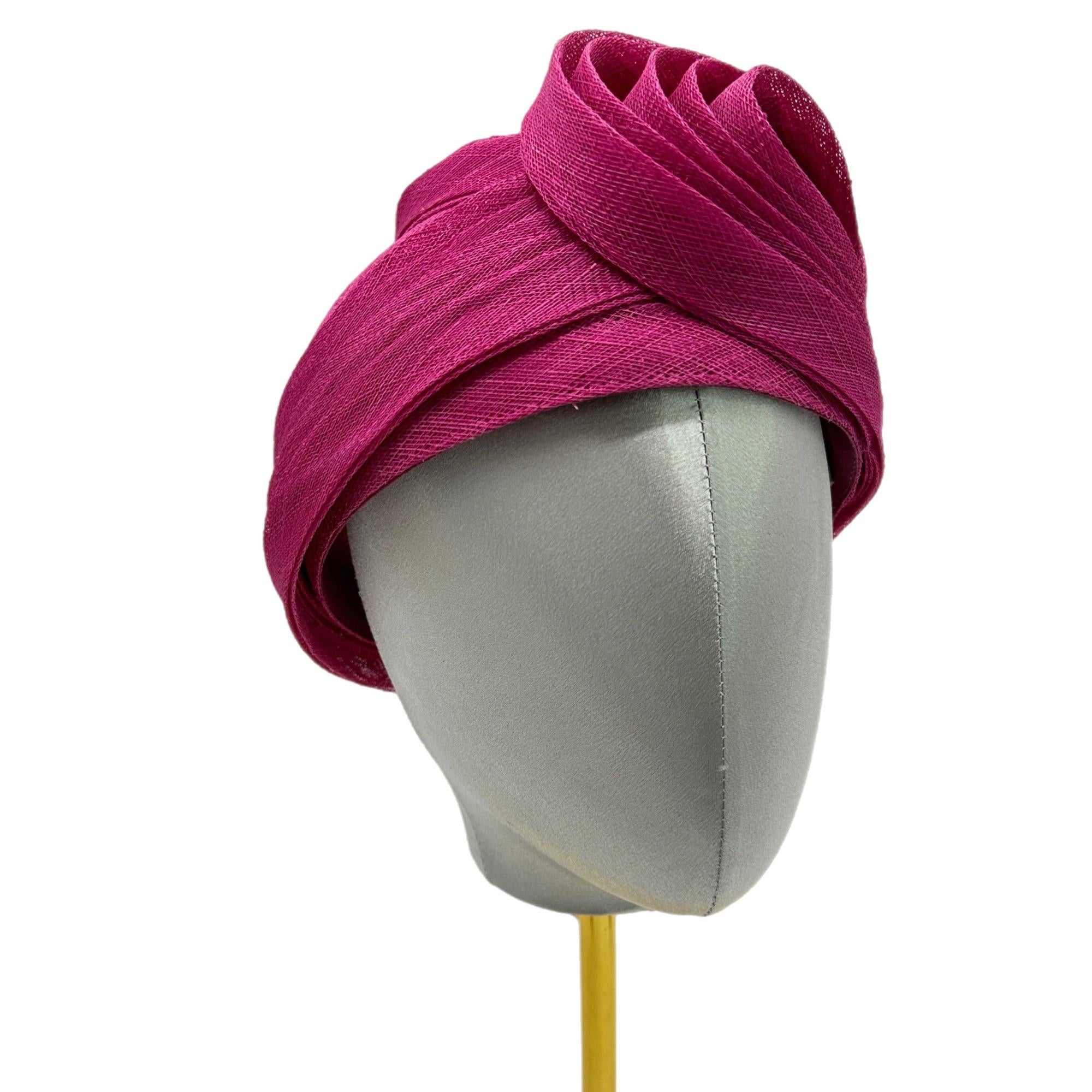 Bright pink fabric turban hat with a soft, gathered texture. The hat is displayed on a gray mannequin head.