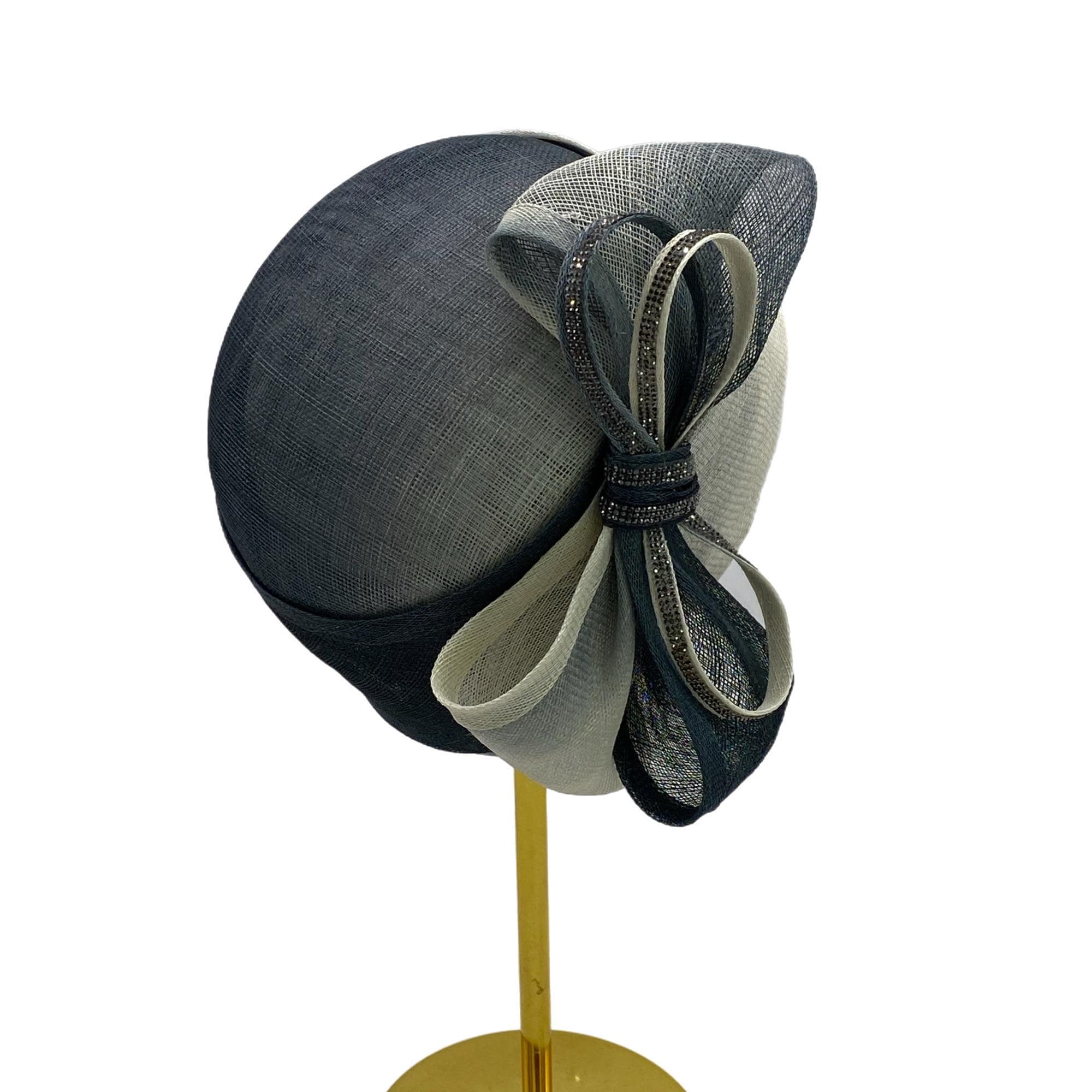 A black and white hat with a large bow