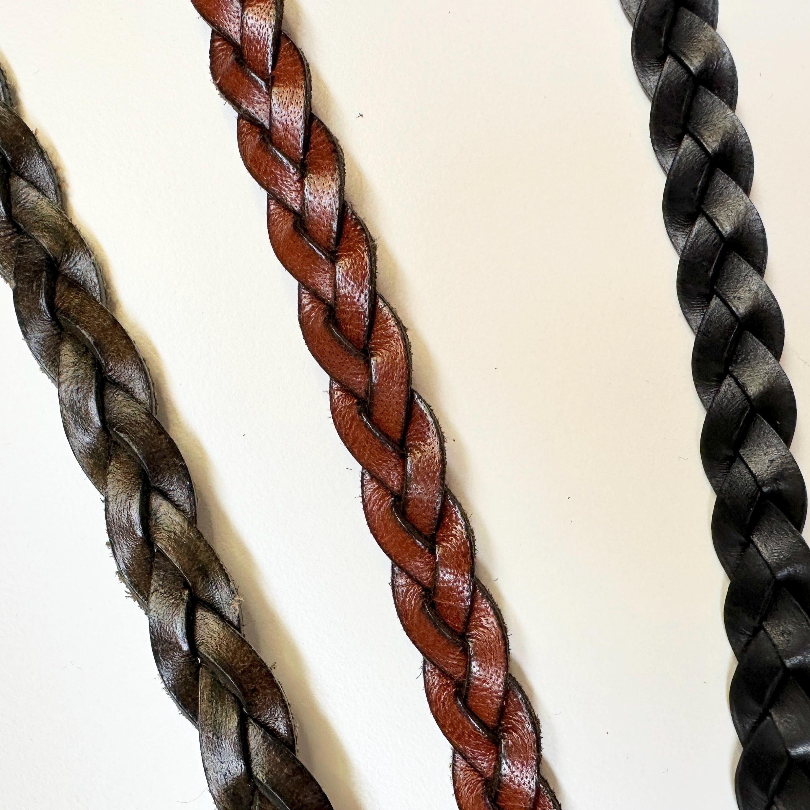 Three braided leather hat belts in brown, green, and black.