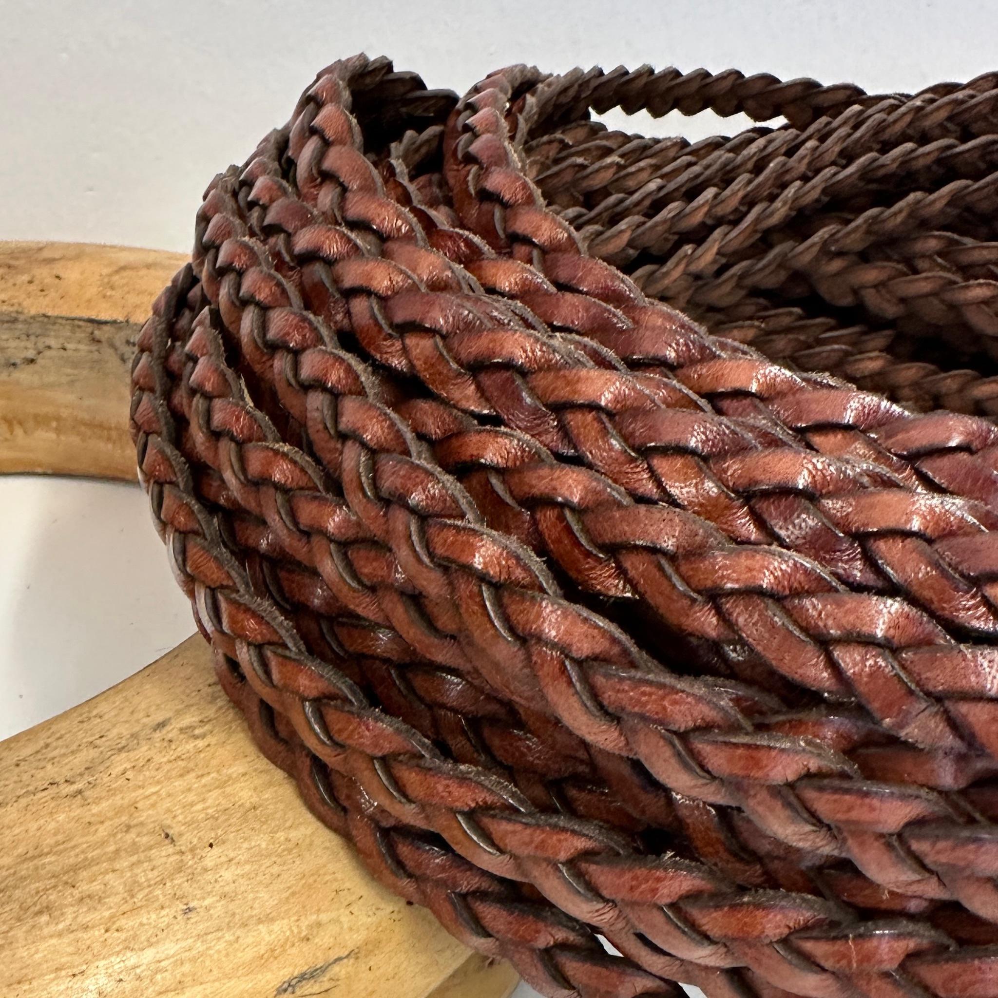 Brown leather hat belt, braided in a thick, intricate pattern.