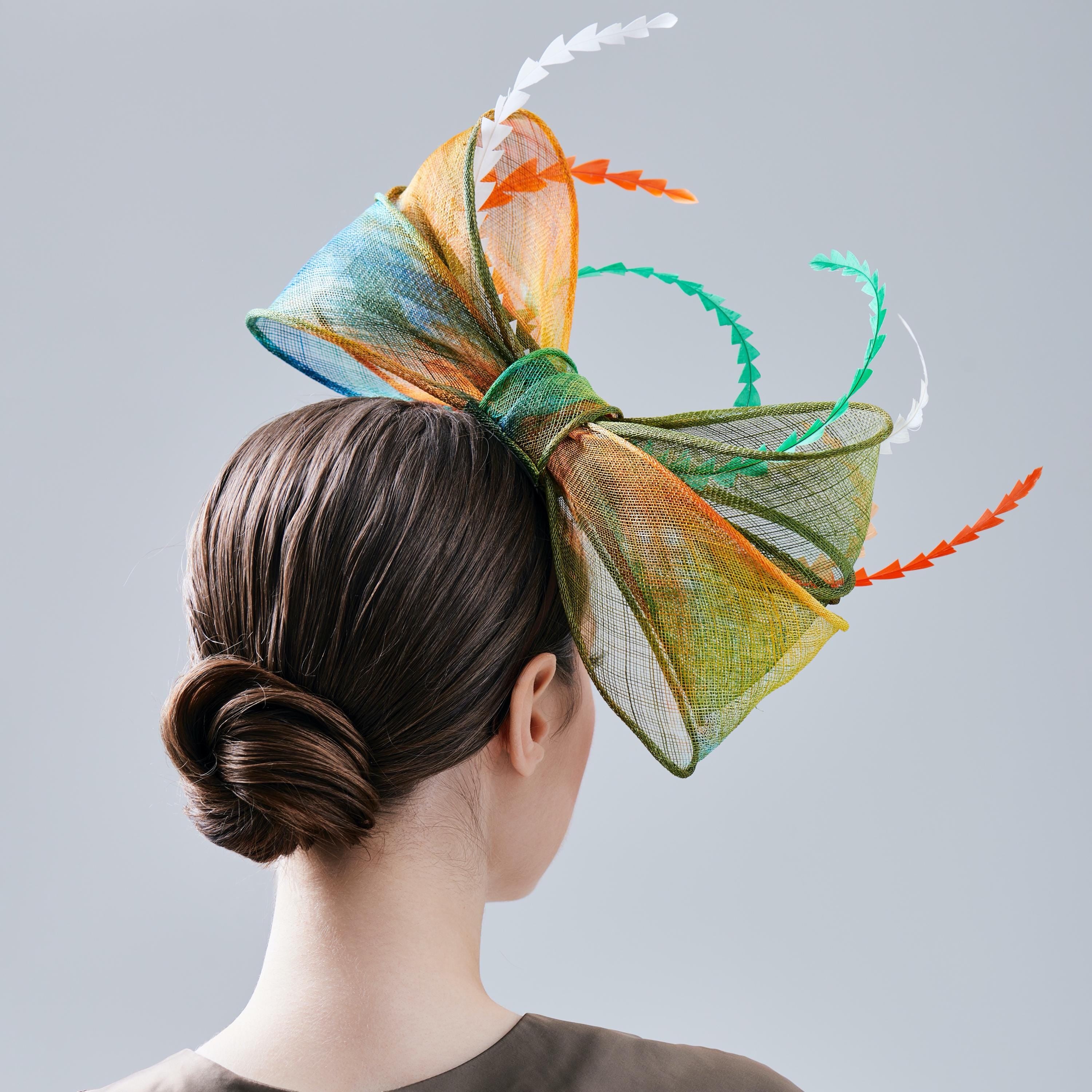 A colorful bow-shaped fascinator hat
