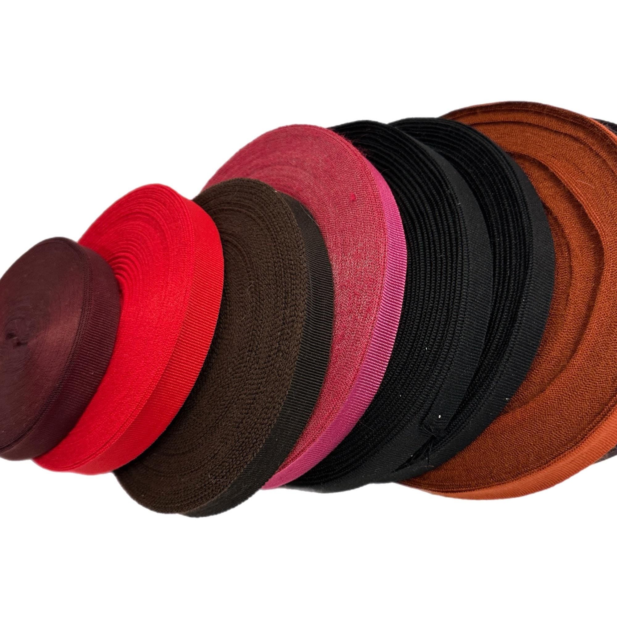 Different colored ribbon rolls. The colors of the ribbon are brown, red, pink, black.