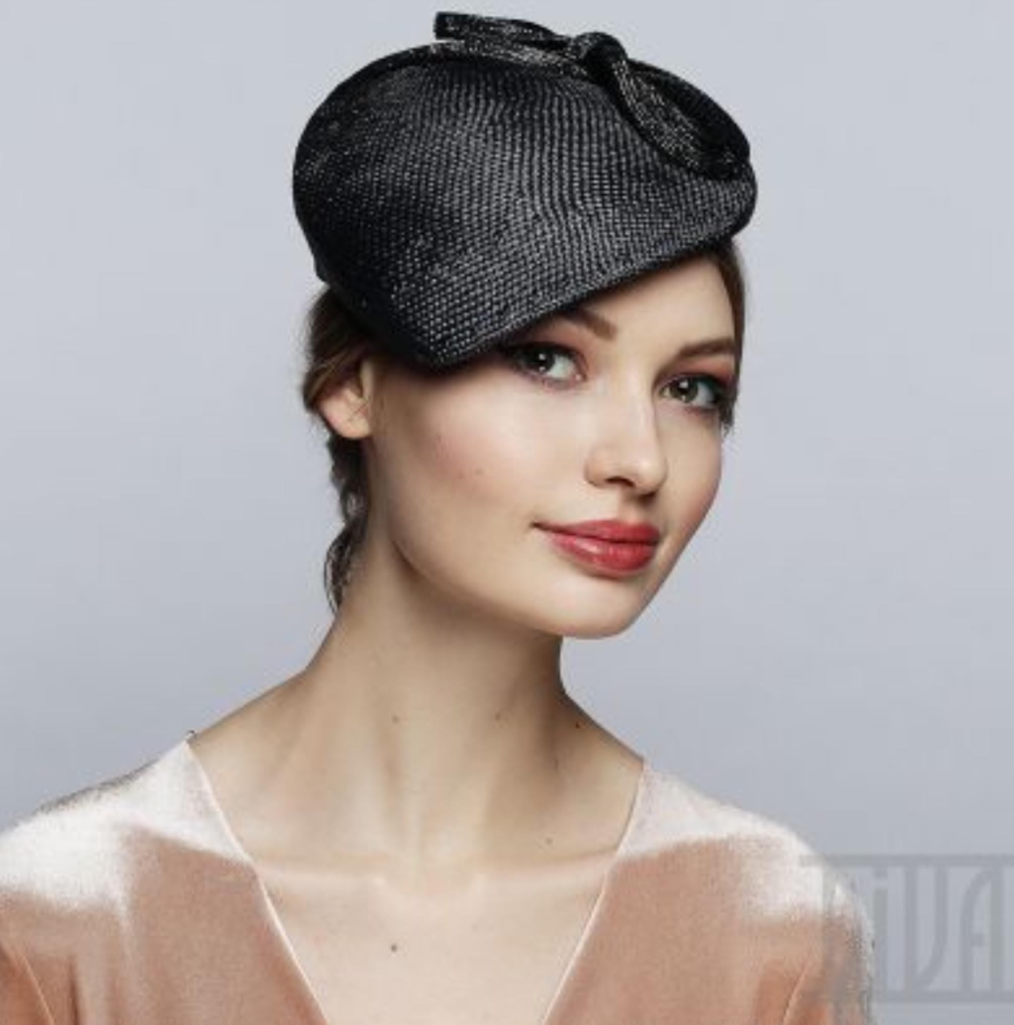 Black fascinator hat with a bow detail.